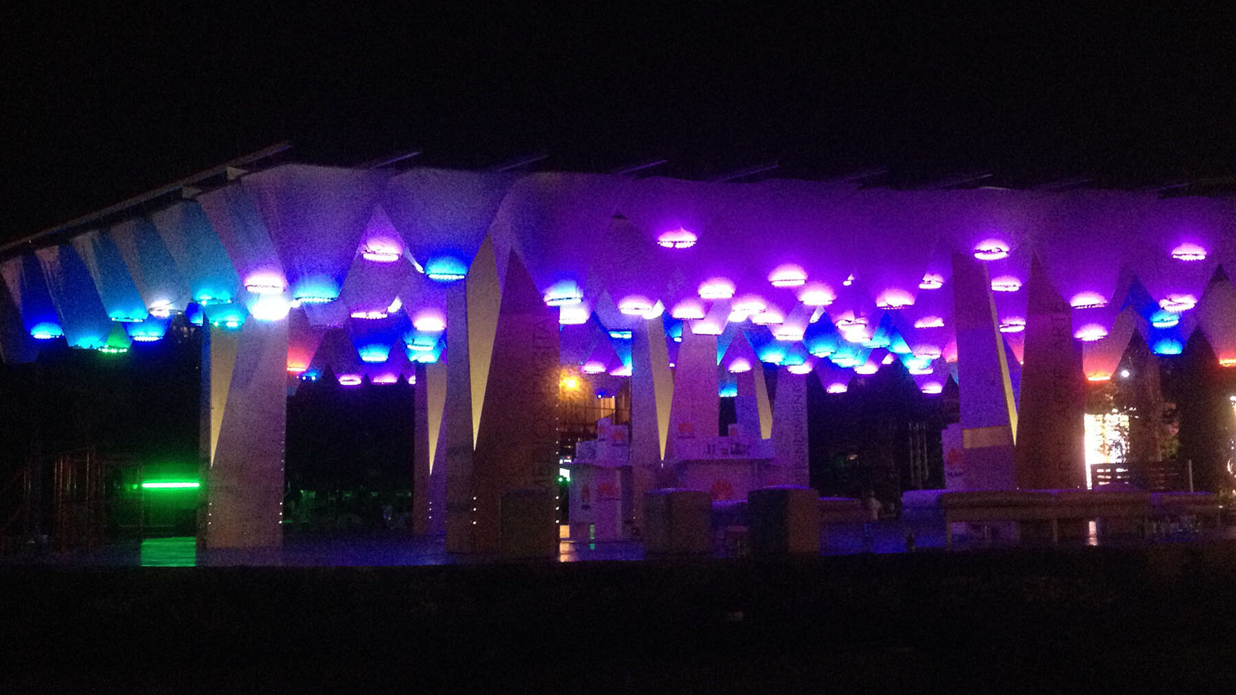 illuminated pavilion of colored funnels overhead